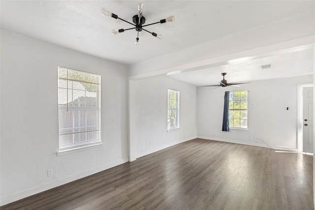 unfurnished living room with dark wood-type flooring, a healthy amount of sunlight, and ceiling fan