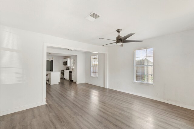 820 Allen St, Denton, TX 76205 - unfurnished living room with ceiling fan, visible vents, plenty of natural light, and wood finished floors