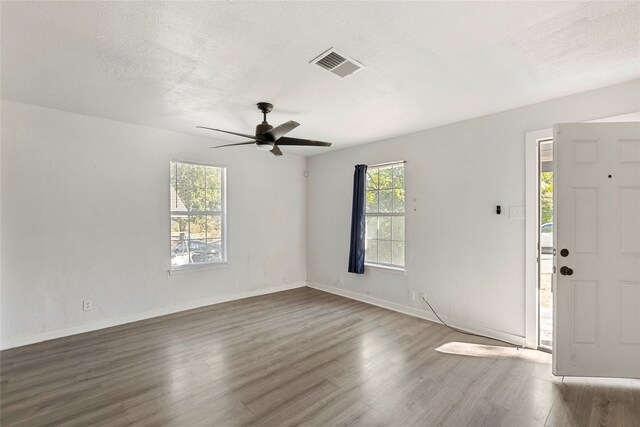 820 Allen St, Denton, TX 76205 - entrance foyer featuring visible vents, wood finished floors, baseboards, ceiling fan, and a textured ceiling