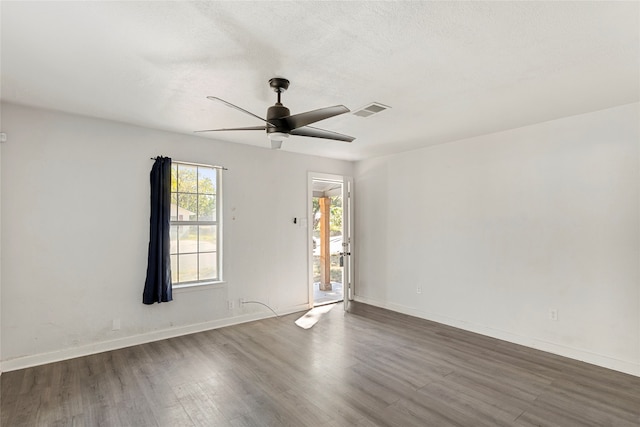 spare room featuring a textured ceiling, wood-type flooring, and ceiling fan