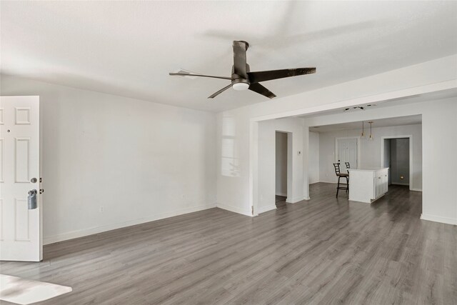 820 Allen St, Denton, TX 76205 - unfurnished living room featuring baseboards, a ceiling fan, and wood finished floors