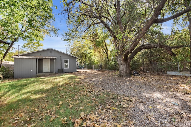 view of yard featuring central AC and an outdoor structure