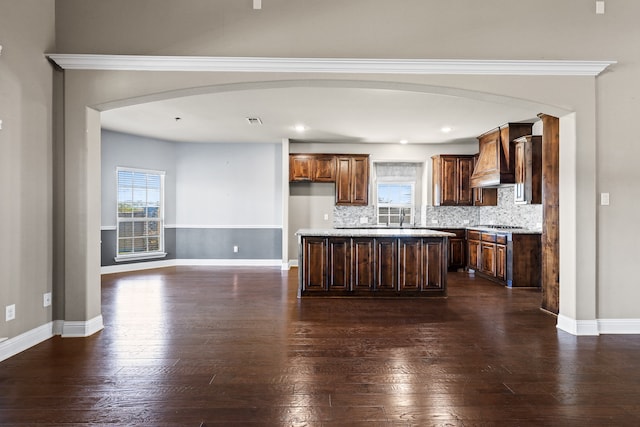 empty room featuring ceiling fan, light carpet, a raised ceiling, and ornamental molding