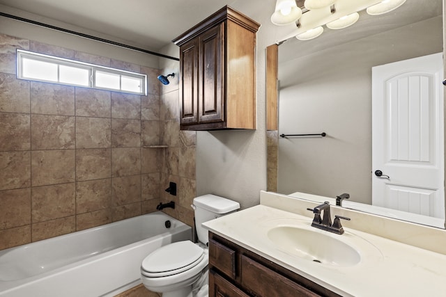 full bathroom with vanity, tiled shower / bath, and toilet