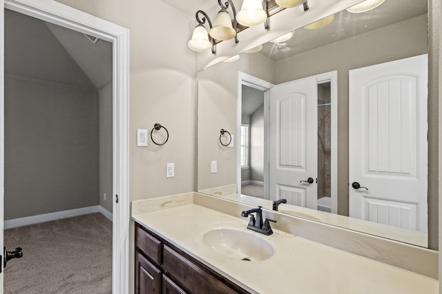 bathroom with walk in shower, vanity, and an inviting chandelier