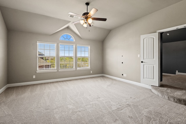 carpeted spare room with lofted ceiling and ceiling fan