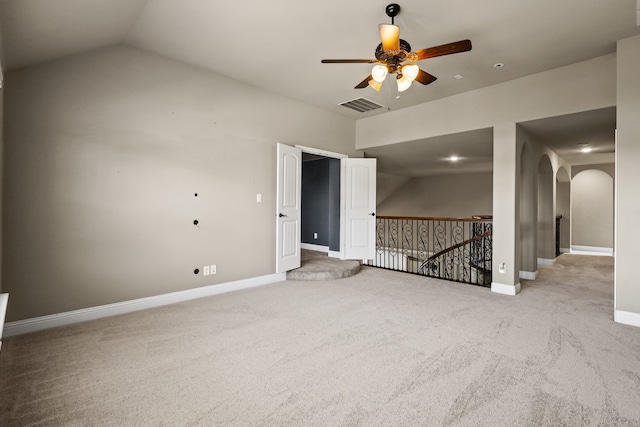 carpeted empty room with ceiling fan and vaulted ceiling