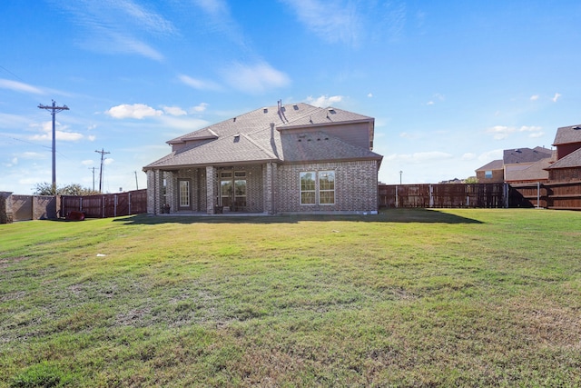 back of property featuring a lawn