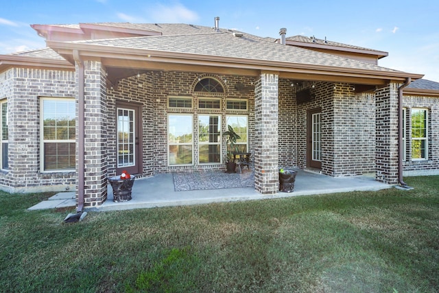 back of house with a lawn and a patio area