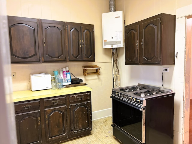 kitchen with dark brown cabinets, water heater, black gas stove, and light countertops