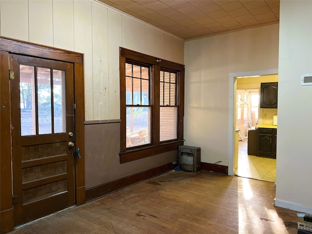 entryway featuring plenty of natural light, baseboards, wood finished floors, and ornamental molding