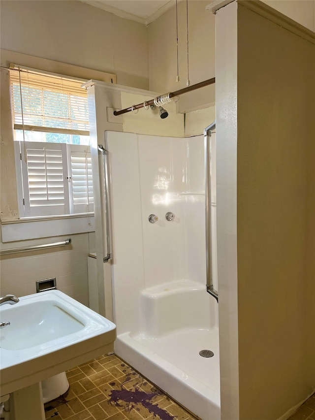 bathroom featuring a sink and a stall shower