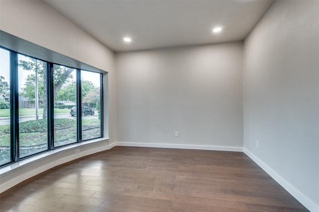 empty room with dark wood-type flooring