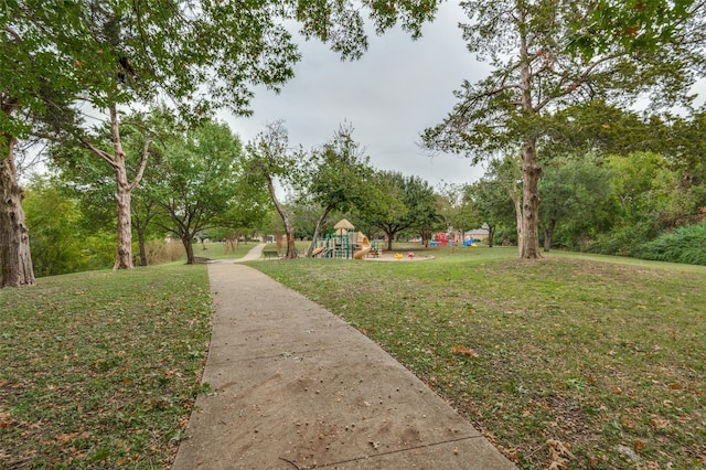 view of community with a lawn and a playground