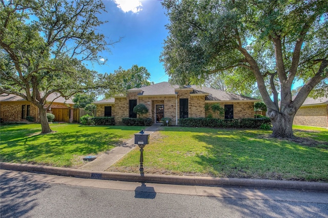 ranch-style home with a front lawn