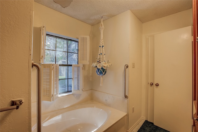 bathroom featuring a tub to relax in and a textured ceiling