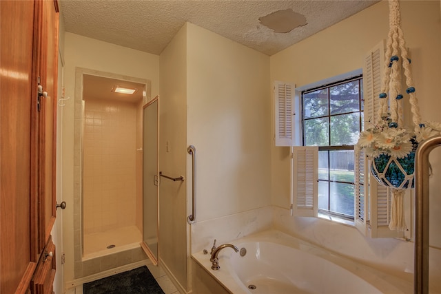 bathroom with plenty of natural light, a textured ceiling, and shower with separate bathtub