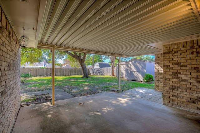 view of patio with a storage unit