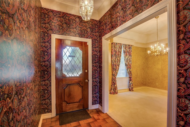 foyer with plenty of natural light, crown molding, a notable chandelier, and carpet