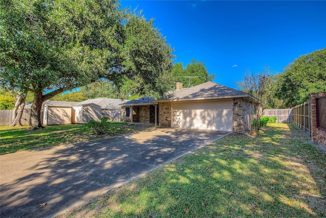 ranch-style home with a front yard and a garage