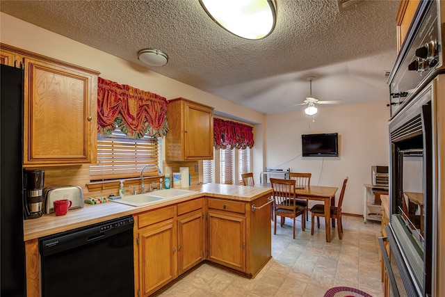 kitchen featuring a textured ceiling, black appliances, sink, and ceiling fan