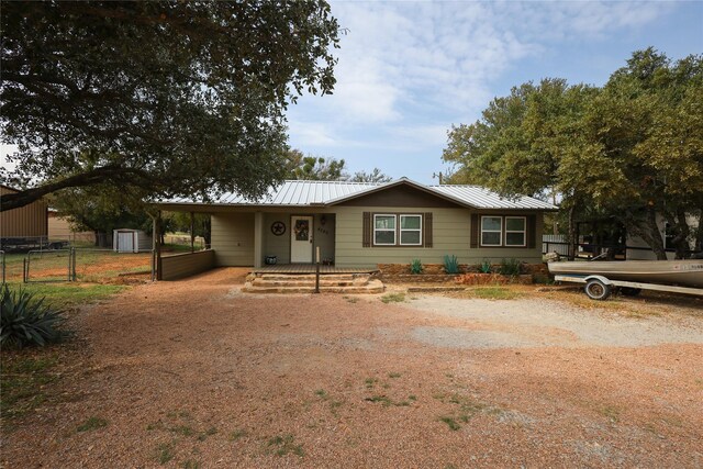 4240 Cheyenne Dr, May, TX 76857 - view of front of property with fence, metal roof, and a storage unit