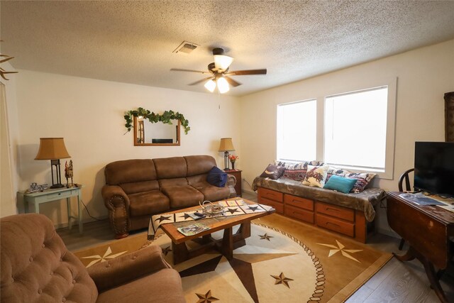 4240 Cheyenne Dr, May, TX 76857 - living area with visible vents, a ceiling fan, a textured ceiling, and wood finished floors