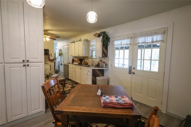 dining room featuring hardwood / wood-style floors, sink, and ceiling fan