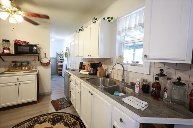 4240 Cheyenne Dr, May, TX 76857 - kitchen with a ceiling fan, black microwave, dishwasher, a sink, and backsplash