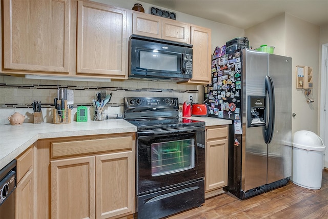 kitchen featuring black appliances, light brown cabinets, and hardwood / wood-style floors