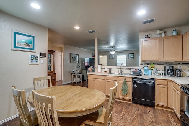 kitchen with light brown cabinets, black appliances, sink, and backsplash