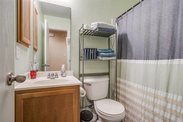 bathroom with vanity, toilet, and a shower with shower curtain