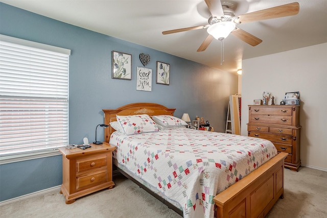 bedroom with light colored carpet and ceiling fan