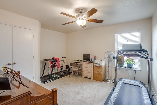 office space featuring light carpet and ceiling fan