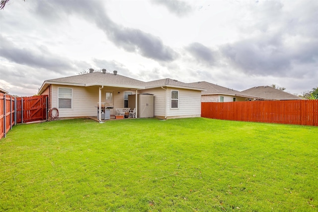 back of house featuring a patio and a yard