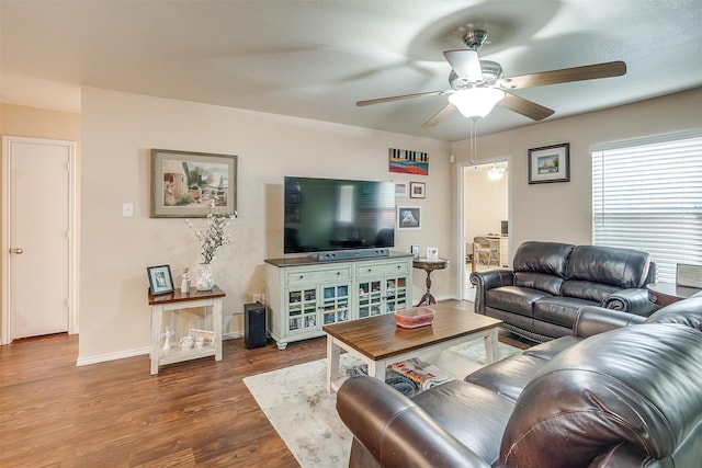 living room with hardwood / wood-style flooring and ceiling fan