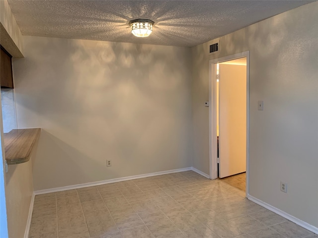 empty room with a textured ceiling