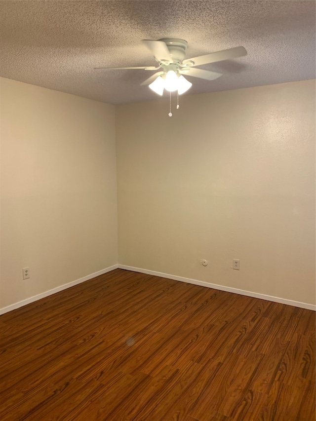 unfurnished room with a textured ceiling, dark hardwood / wood-style floors, and ceiling fan