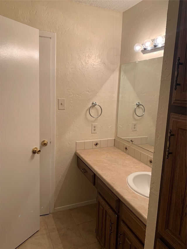 bathroom featuring vanity, a textured ceiling, and tile patterned floors