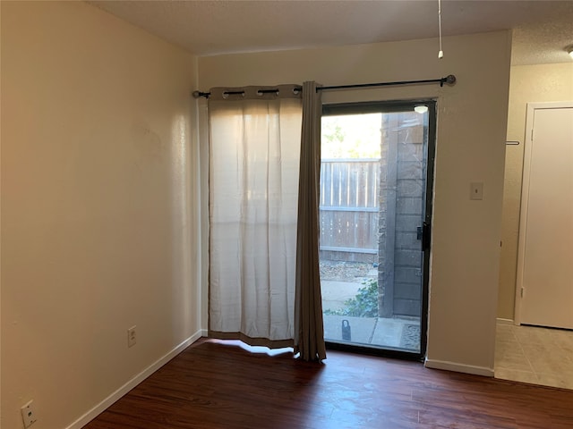 unfurnished room with dark hardwood / wood-style floors