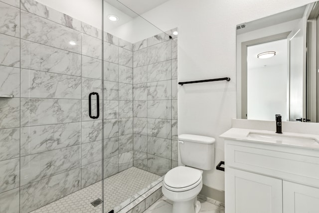 bathroom featuring vanity, toilet, and a shower with door