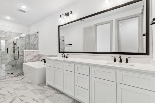 bathroom featuring vanity and shower with separate bathtub