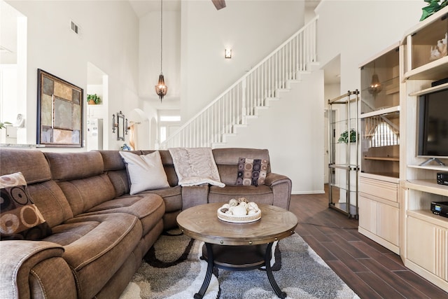 living room featuring a towering ceiling