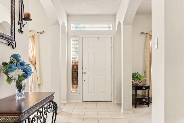 tiled entrance foyer featuring a textured ceiling