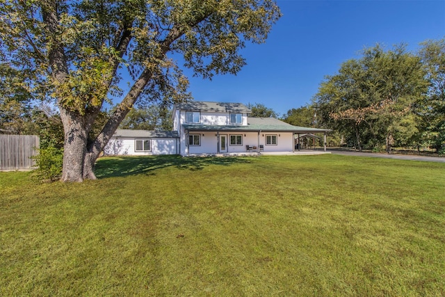 view of front facade featuring a front yard and a carport