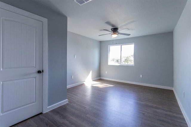 empty room featuring ceiling fan and dark wood-type flooring