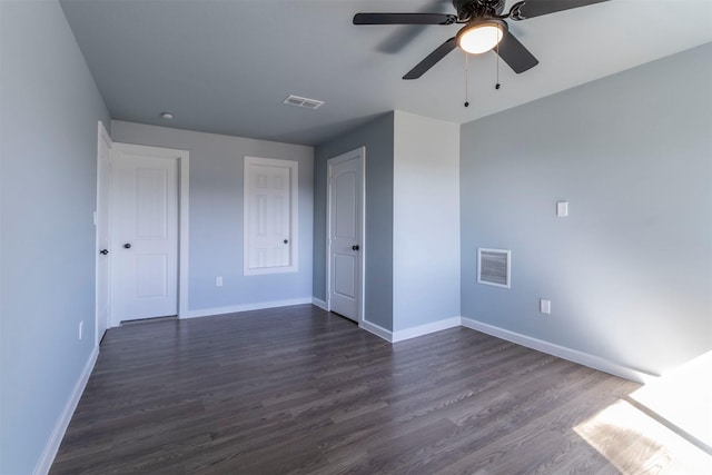 unfurnished bedroom with ceiling fan and dark wood-type flooring