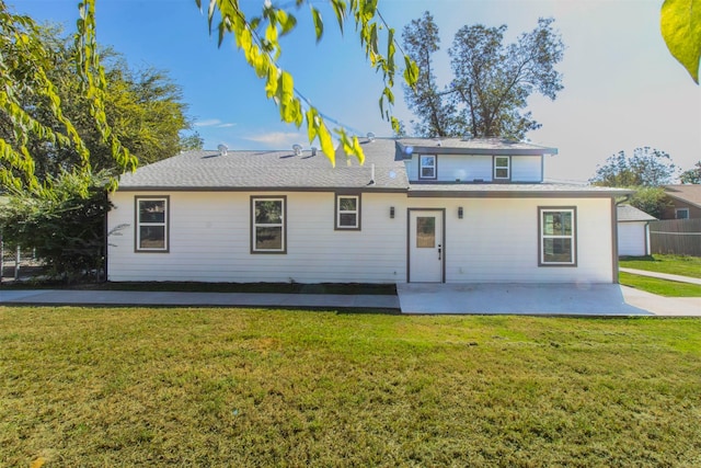 back of house with a patio area and a lawn