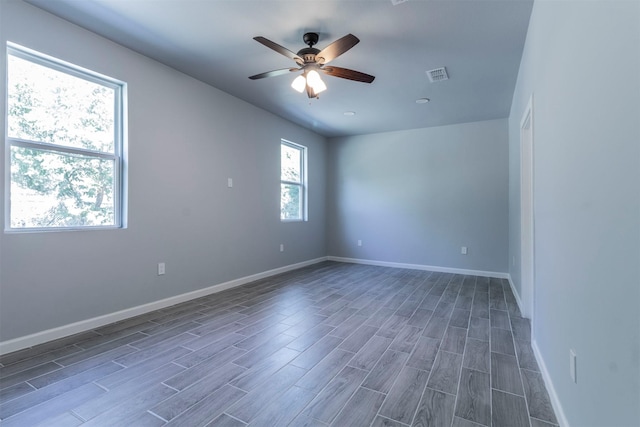 empty room featuring ceiling fan and dark hardwood / wood-style flooring