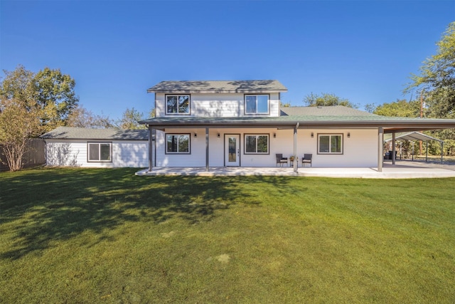 back of property featuring a lawn and a patio